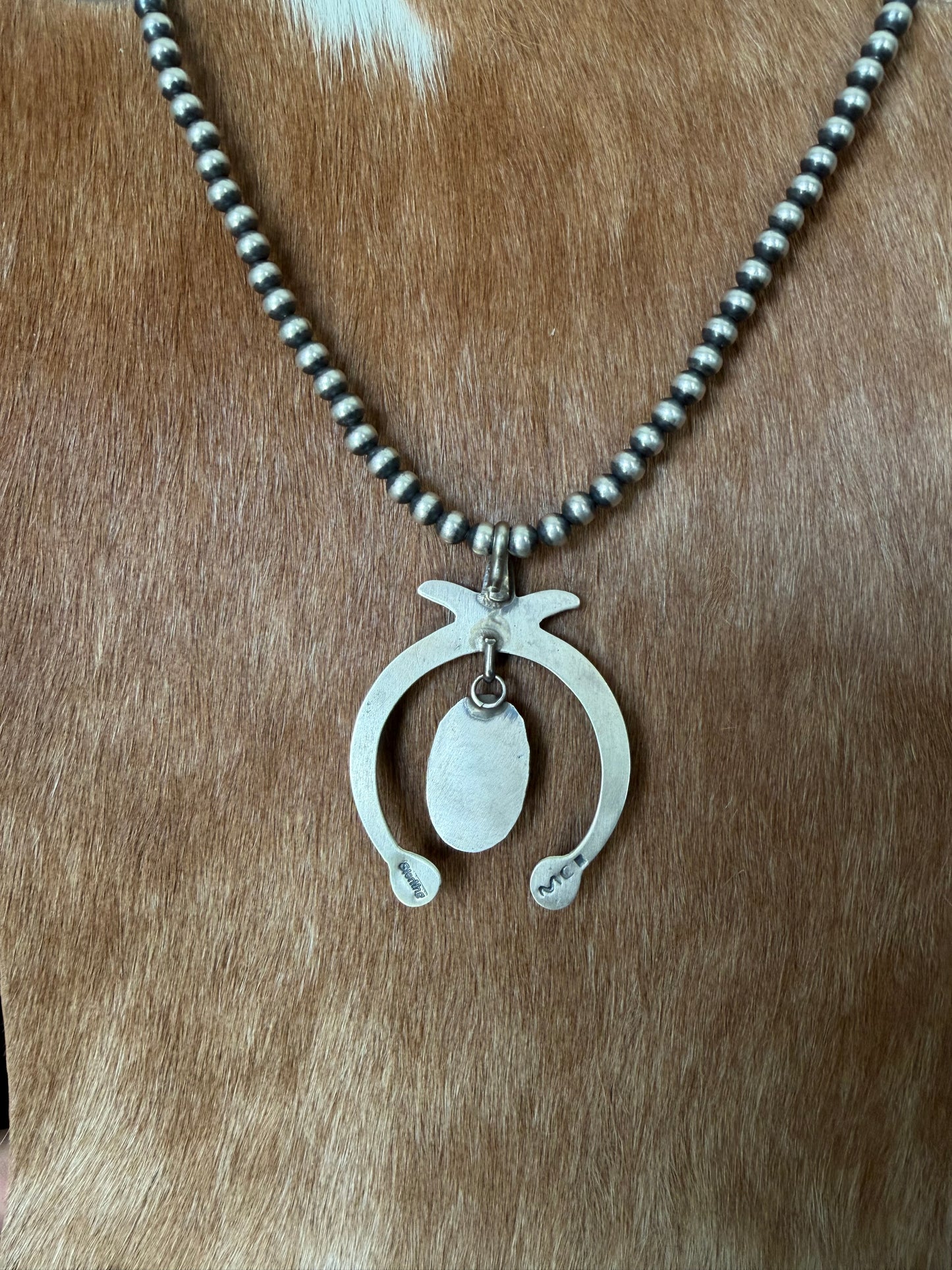 Native made turquoise naja pendant