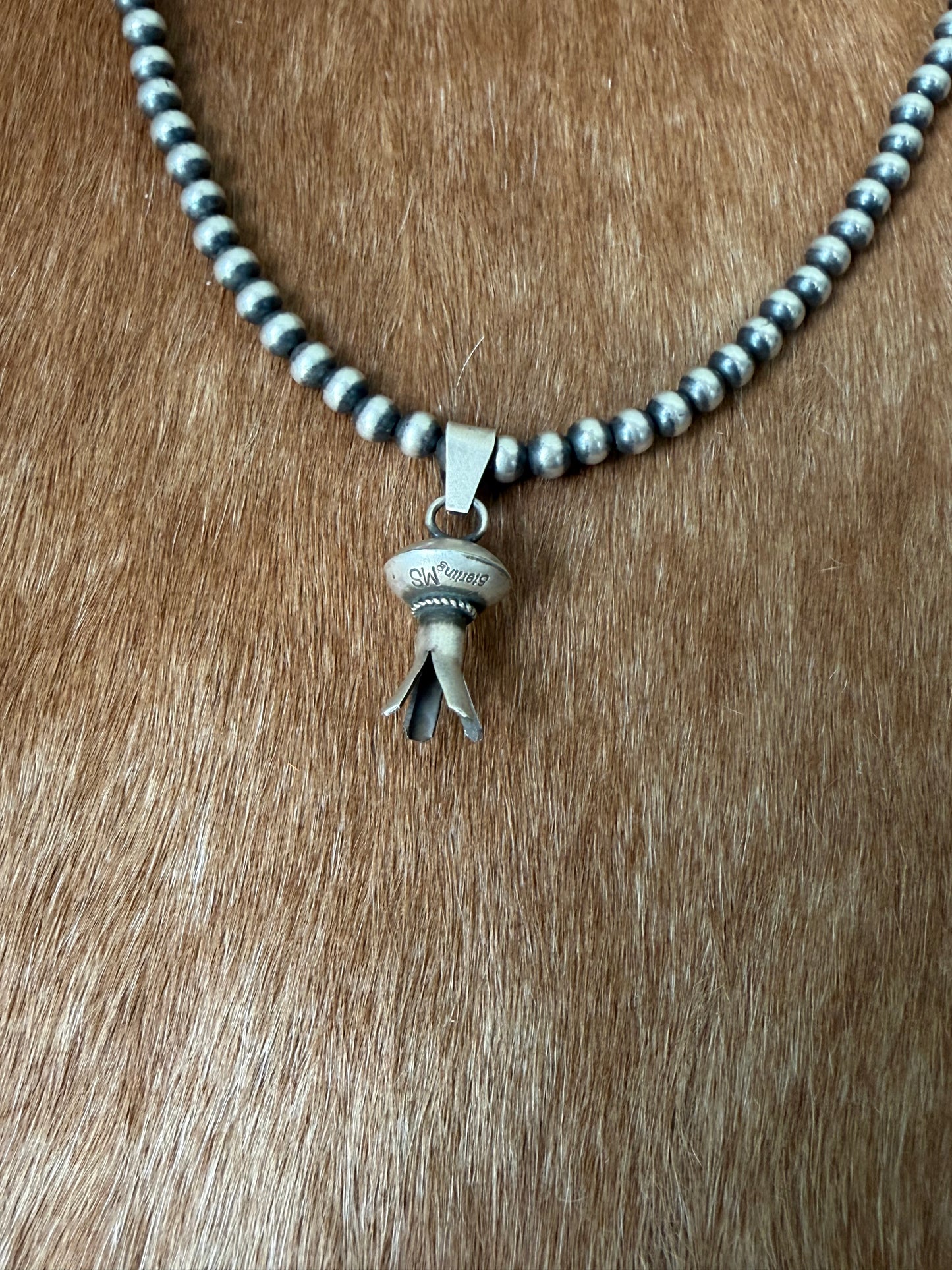 Native made blossom pendant